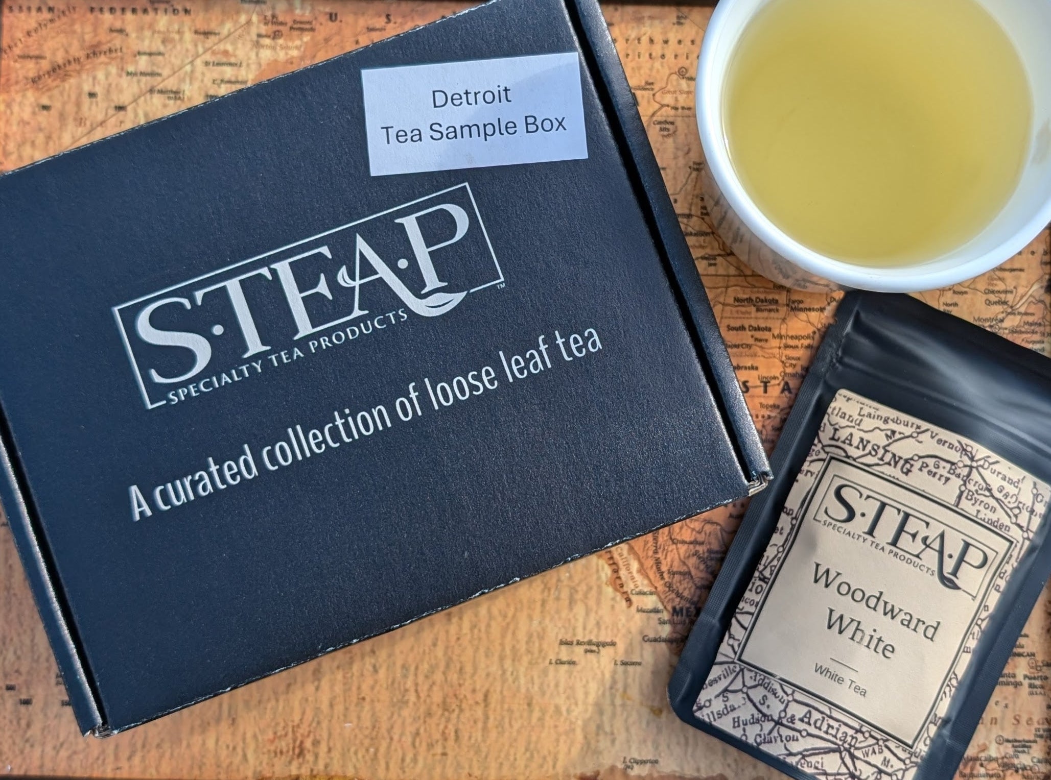 S-TEAP tea packaging with a cup of tea on a wooden tray
